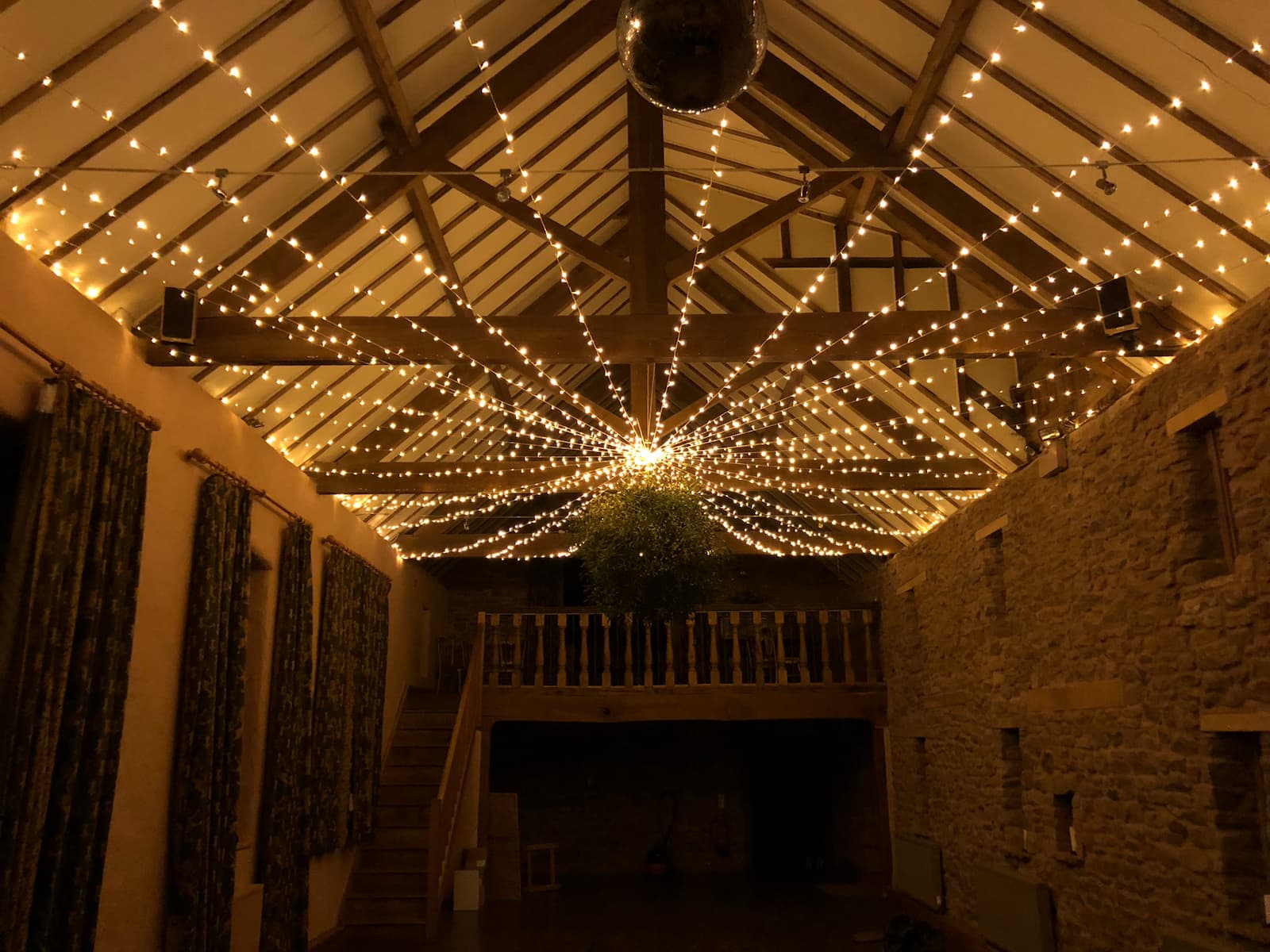 Marquee lit at dusk beside the water